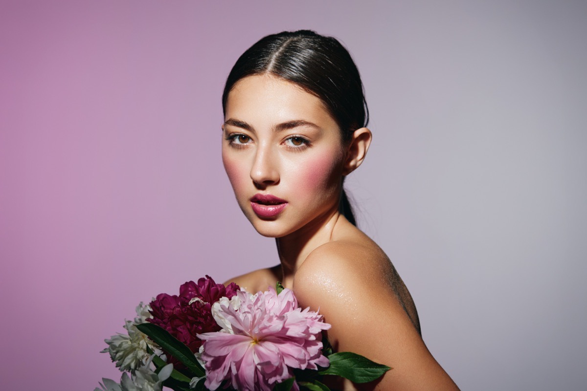 Woman with smooth, radiant skin and flowers