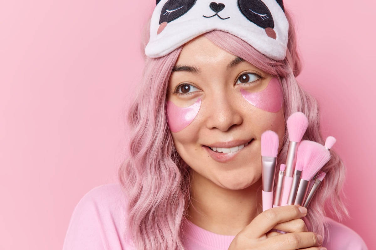 Woman with glowing skin and pink hair