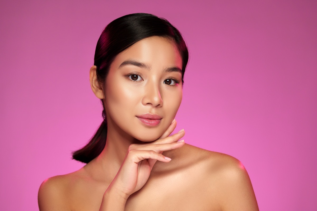 Model with clear, even-toned skin on pink